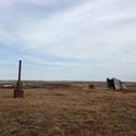 Historic drilling supplies across tundra landscape.